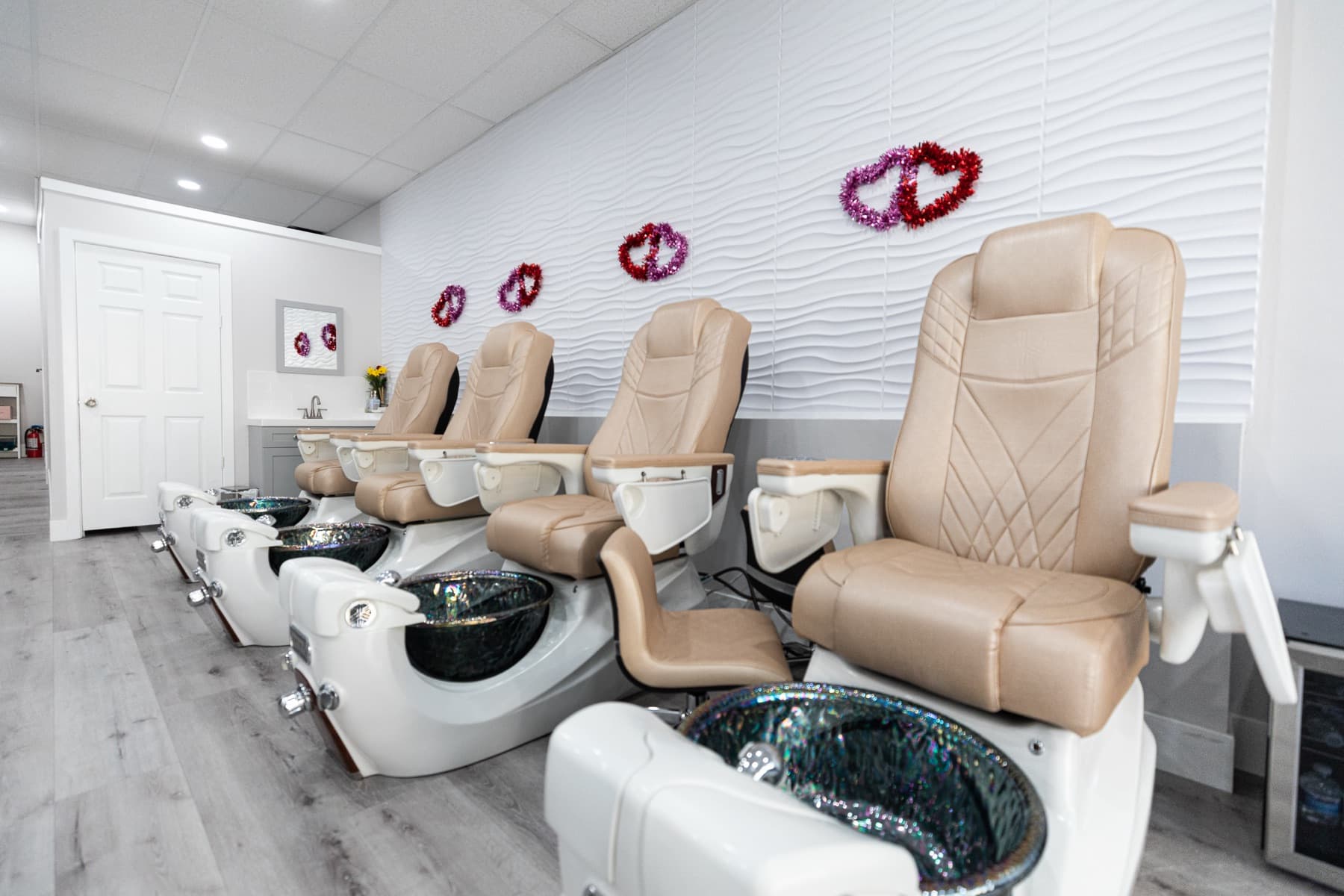 A row of pedicure chairs at Kim Nails and Beauty Lounge